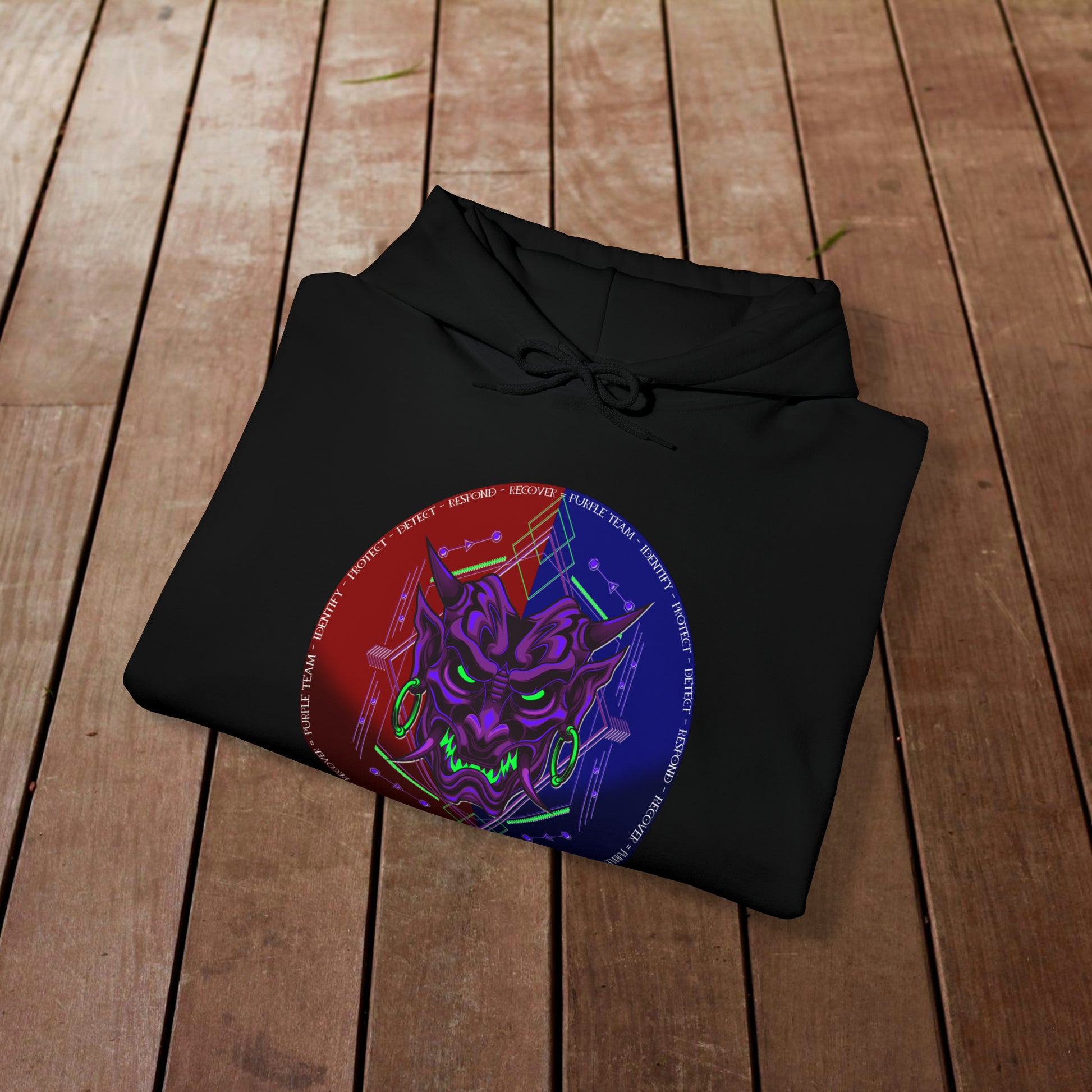 Black hoodie with a purple oni demon mask in a red and blue circular background. White text around the circle "Identify, Protect, Detect, Respond, Recover" cybersecurity framework.