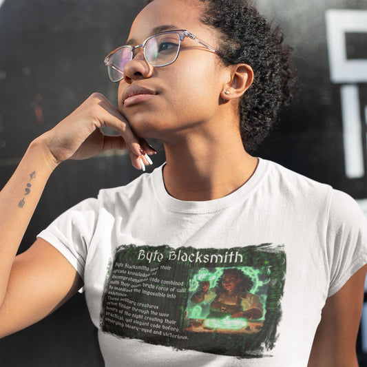 A young African American woman wearing a white t shirt with the text "Byte Blacksmith" on it. The primary graphic appears weathered and has an image of a dark complexioned female character in a workshop creating with magic. The RPG-style character description of a software developer as a Byte Blacksmith appears next to the image.